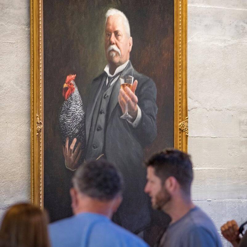 People in front of a painting of Domenico Canale holding Nico the rooster