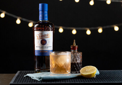 Bottled-In-Bond on a table with a glass and a lemon